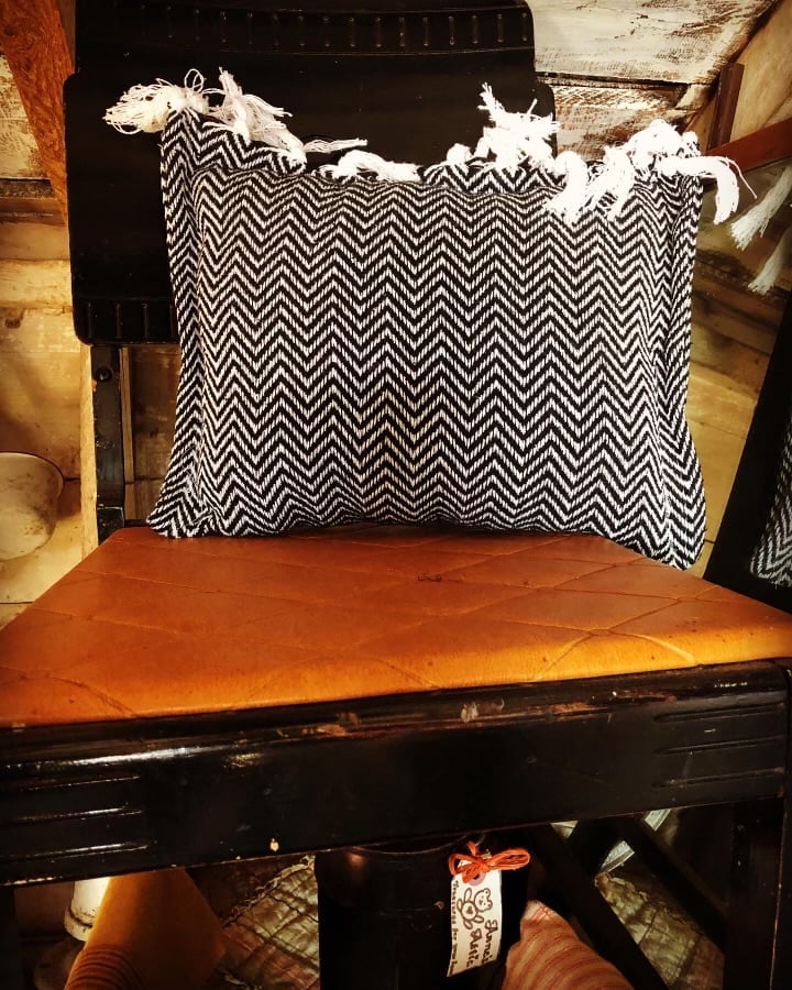 Three white ceramic horses on patterned fabric