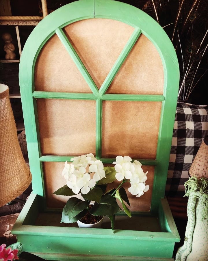 Green arched window planter with white flowers