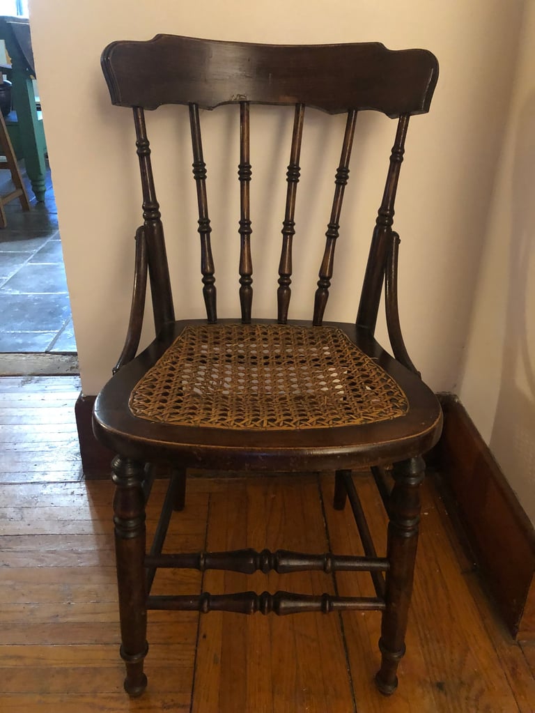 Black wooden chair with woven wicker seat