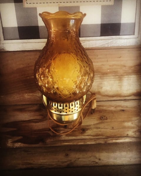 Amber glass hurricane lamp with brass base