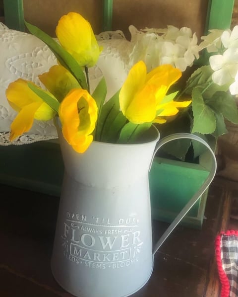 Yellow tulips in white ceramic vase