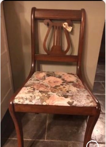 Wooden dining chair with lyre-shaped backrest and floral upholstered seat cushion